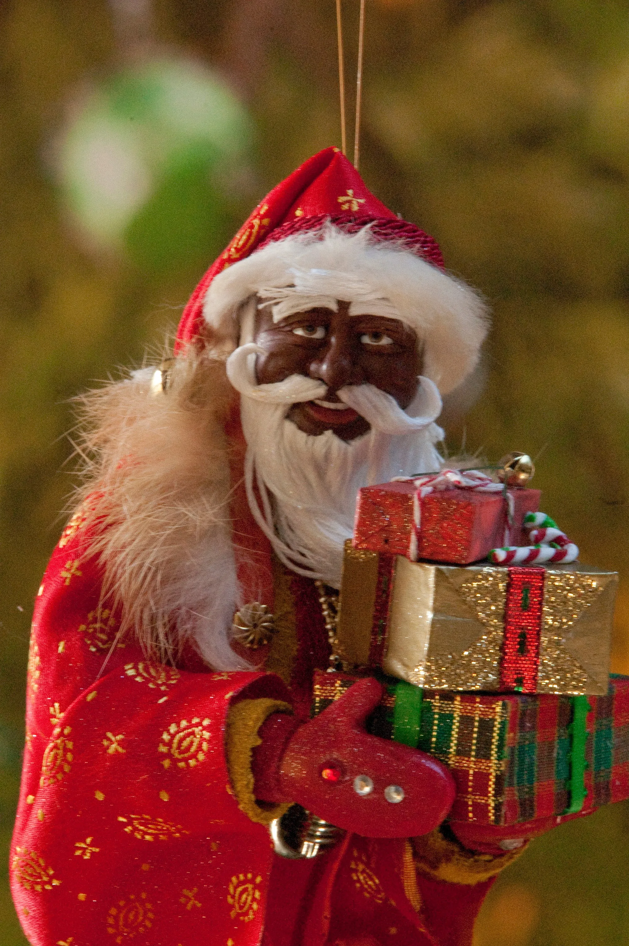 African American Santa Claus Decoration - Arm full of Christmas presents - Richly textured fur trimmed red and gold coat & cap - Golden mittens